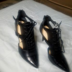 Nine West black 3 inch heels. Lace in front 2 belt buckgel on side w/ open sides